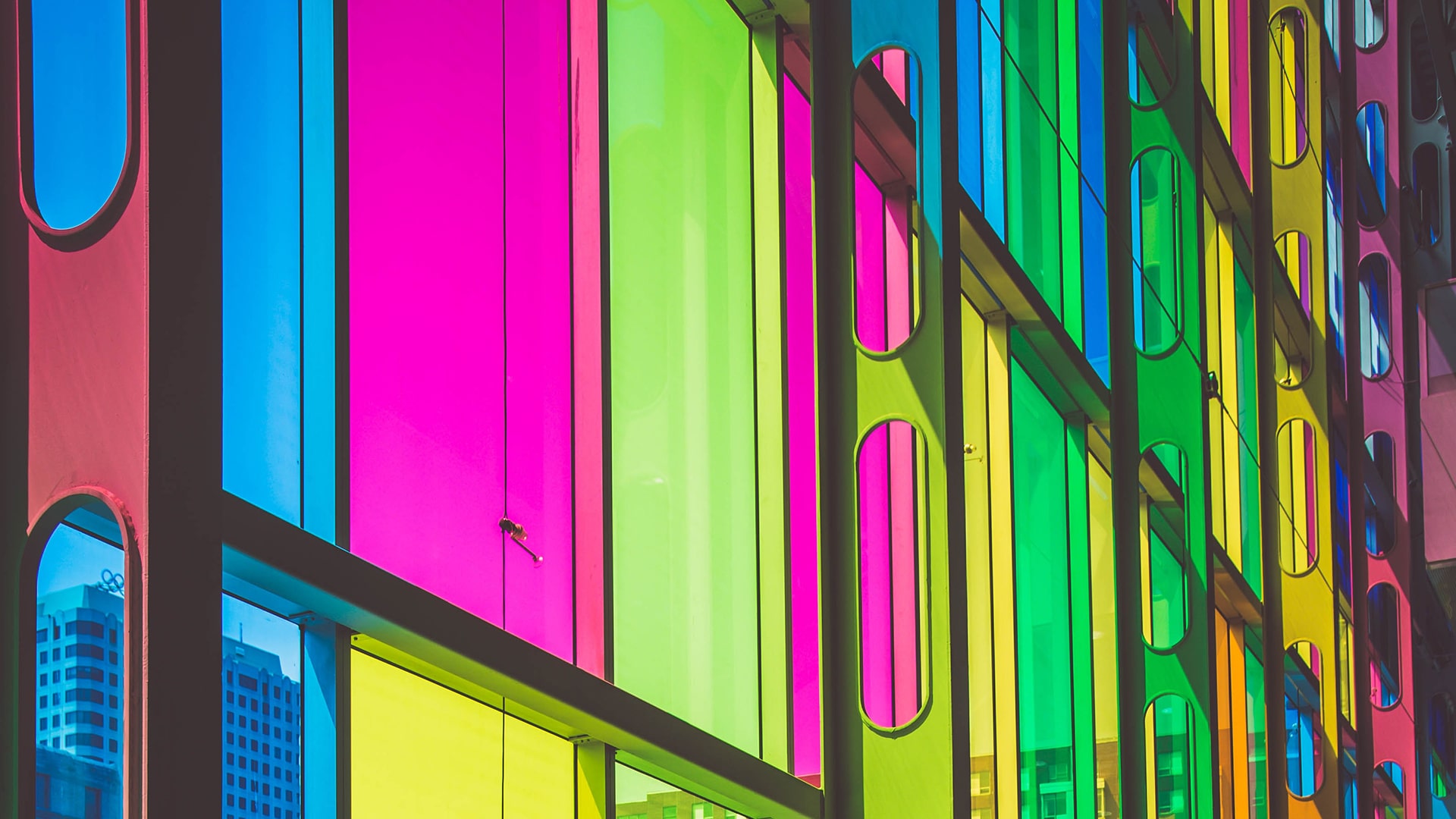 Windows with coloured glass in yellow, green and pink colours.