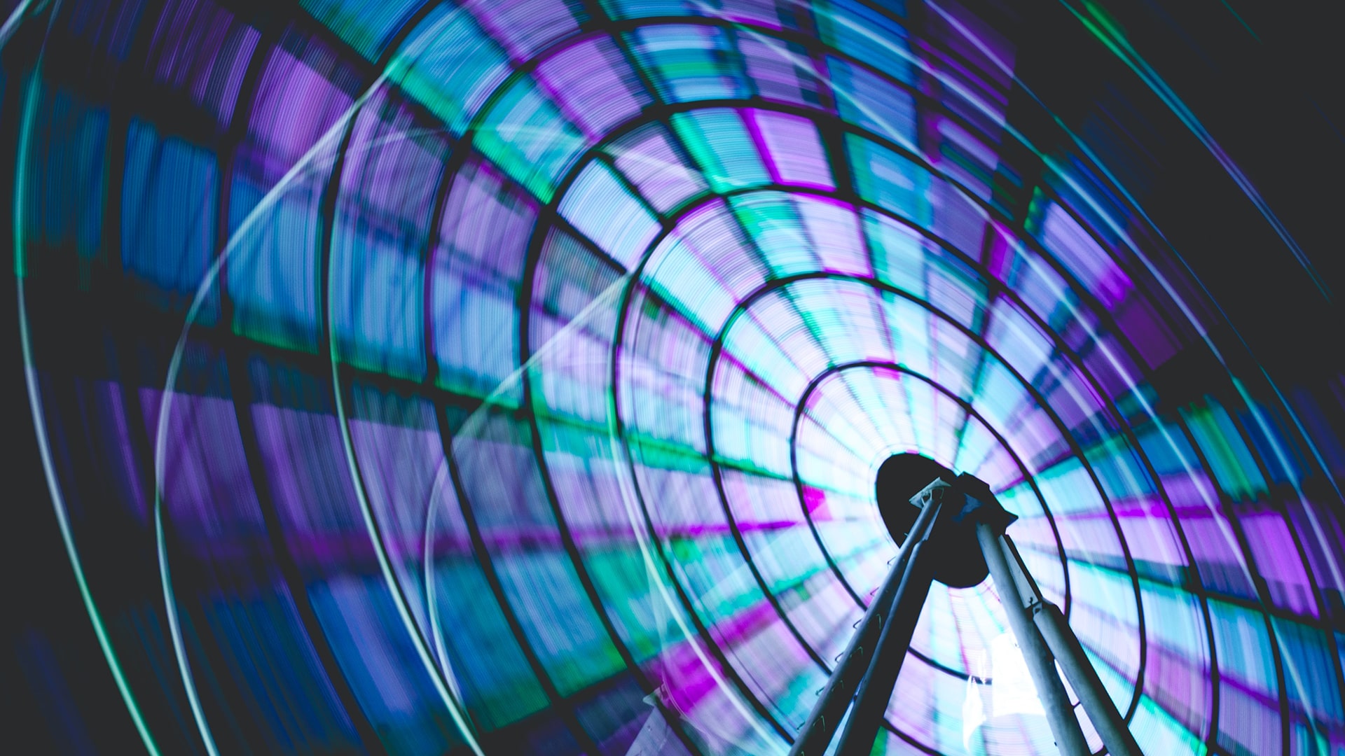 Ferris wheel spinning and shinning in blue and purple colours.