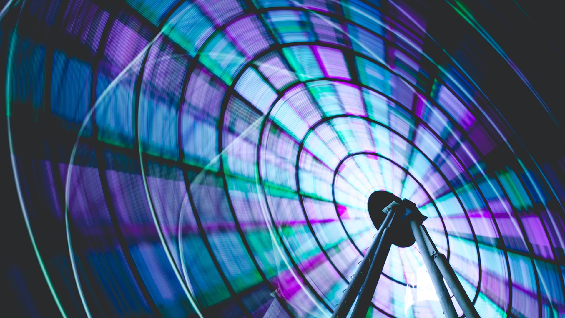 Ferris wheel spinning and shinning in blue and purple colours. 